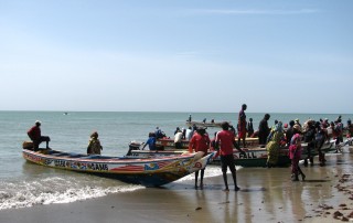 Fisherfolk prepare to head out on their boats for the day